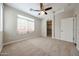 Bedroom featuring plush carpeting, a ceiling fan, and a walk-in closet at 2150 W Alameda Rd # 1122, Phoenix, AZ 85085