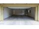 Empty two car garage with neutral colored walls and two white doors at 2150 W Alameda Rd # 1122, Phoenix, AZ 85085