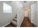 Bright hallway featuring wood-look tile flooring and a staircase with carpet at 2150 W Alameda Rd # 1122, Phoenix, AZ 85085