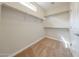 Spacious walk-in closet offers ample storage with built-in shelving and neutral carpeting at 2150 W Alameda Rd # 1122, Phoenix, AZ 85085