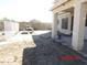 View of a backyard with a covered patio, block wall, and wrought iron fence at 22016 W Loma Linda Blvd, Buckeye, AZ 85326