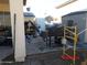 Cluttered backyard with grill and partially covered patio at 22016 W Loma Linda Blvd, Buckeye, AZ 85326