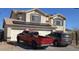 Two-story home with solar panels over the garage and a well-maintained driveway at 22016 W Loma Linda Blvd, Buckeye, AZ 85326