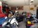 Garage interior with a motorcycle and assorted items; advertising sign visible on wall at 22016 W Loma Linda Blvd, Buckeye, AZ 85326