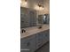 Modern bathroom with double sink vanity, sleek fixtures, and a well-lit mirror at 24116 N 172Nd Ave, Surprise, AZ 85387