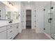 Elegant bathroom featuring double sinks, walk-in shower, and a walk-in closet at 24116 N 172Nd Ave, Surprise, AZ 85387