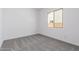A bedroom featuring a window providing natural light and gray carpeting at 24116 N 172Nd Ave, Surprise, AZ 85387