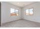 Sunny bedroom with two windows providing ample natural light and neutral-toned carpet at 24116 N 172Nd Ave, Surprise, AZ 85387