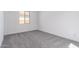 A bedroom featuring a window providing natural light and gray carpeting at 24116 N 172Nd Ave, Surprise, AZ 85387