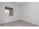Bright, minimalist bedroom with a large window offering natural light at 24116 N 172Nd Ave, Surprise, AZ 85387