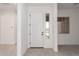 Bright foyer featuring tile floors and a white front door with sidelight, providing an open and welcoming space at 24116 N 172Nd Ave, Surprise, AZ 85387