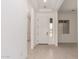 Bright foyer featuring tile floors and a white front door with sidelight, providing an open and welcoming space at 24116 N 172Nd Ave, Surprise, AZ 85387