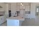 Bright kitchen features white cabinets, stainless steel appliances, a large island, and modern finishes at 24116 N 172Nd Ave, Surprise, AZ 85387
