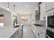Well-equipped kitchen boasts modern appliances, white cabinets, and a functional layout at 24116 N 172Nd Ave, Surprise, AZ 85387