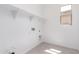 Functional laundry room features convenient shelving and utility connections for efficient laundry tasks at 24116 N 172Nd Ave, Surprise, AZ 85387