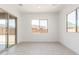 Bright living room with large windows and sliding glass door to the exterior at 24116 N 172Nd Ave, Surprise, AZ 85387