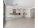 Open-concept living area flows into a modern kitchen with sliding glass doors at 24116 N 172Nd Ave, Surprise, AZ 85387