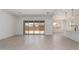 Expansive living area with tile flooring, slider door, and adjacent kitchen at 24116 N 172Nd Ave, Surprise, AZ 85387