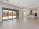Open living room with sliding glass doors leading to the backyard and view of the kitchen at 24116 N 172Nd Ave, Surprise, AZ 85387