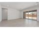 Bright living room featuring sliding glass doors to the backyard and light tile floors at 24116 N 172Nd Ave, Surprise, AZ 85387