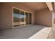 Covered patio with sliding glass doors offers a seamless transition to outdoor living and relaxation at 24116 N 172Nd Ave, Surprise, AZ 85387