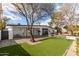 Spacious backyard featuring low-maintenance artificial grass, a paved patio, and mature trees at 2632 E Mountain View Rd, Phoenix, AZ 85028