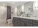 Bathroom featuring a double sink vanity, modern lighting, and a shower with a gray curtain at 2632 E Mountain View Rd, Phoenix, AZ 85028