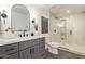 Modern bathroom featuring a sleek vanity, frameless glass shower, and stylish black fixtures at 2632 E Mountain View Rd, Phoenix, AZ 85028