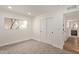 Cozy bedroom with neutral carpet, natural light and adjacent view to a bathroom at 2632 E Mountain View Rd, Phoenix, AZ 85028