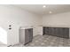 Bright laundry room featuring a white door, modern cabinetry, beautiful countertops, and unique tile flooring at 2632 E Mountain View Rd, Phoenix, AZ 85028