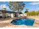 Backyard pool featuring a stone waterfall feature, a covered patio, and lush landscaping at 2632 E Mountain View Rd, Phoenix, AZ 85028