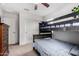 Neutral bedroom showcasing a wood bunk bed, closet and neutral carpet at 27878 N 175Th Dr, Surprise, AZ 85387