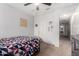 Bright bedroom featuring a bed with geometric bedding, carpeted floor and a ceiling fan at 27878 N 175Th Dr, Surprise, AZ 85387