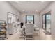 Bright dining room with white furniture, decorative wall art, and access to the backyard through sliding glass doors at 27878 N 175Th Dr, Surprise, AZ 85387