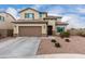 Two-story home showcasing a well-manicured, low-maintenance yard with desert landscaping and a two-car garage at 27878 N 175Th Dr, Surprise, AZ 85387