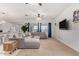 Open concept living room with a large sectional sofa, big windows, and neutral color scheme at 27878 N 175Th Dr, Surprise, AZ 85387