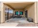 Relaxing covered patio featuring seating, a coffee table, and patterned rug at 27878 N 175Th Dr, Surprise, AZ 85387