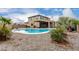 Gorgeous swimming pool with lush landscaping and a covered patio in this desert oasis backyard at 27878 N 175Th Dr, Surprise, AZ 85387