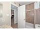 Neutral bathroom with a tiled shower and a view into an adjacent bedroom at 3004 W Anderson Dr, Phoenix, AZ 85053