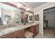 Bathroom featuring double sinks with granite counters, a large mirror, and stylish decor at 3004 W Anderson Dr, Phoenix, AZ 85053