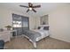 Bedroom featuring a bed with neutral bedding, a window with sheer curtains, and a ceiling fan at 3004 W Anderson Dr, Phoenix, AZ 85053