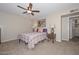 Cozy bedroom featuring soft carpet, ceiling fan, and serene decor for a restful retreat at 3004 W Anderson Dr, Phoenix, AZ 85053