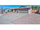 Street view of a single-story house, showcasing its brick exterior and low-maintenance desert landscaping at 3004 W Anderson Dr, Phoenix, AZ 85053