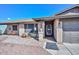 Close up of the front entrance features charming brickwork, a security screen door, and desert landscaping at 3004 W Anderson Dr, Phoenix, AZ 85053