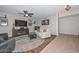 Cozy living room featuring a ceiling fan, an entertainment center with a fireplace, and comfortable seating at 3004 W Anderson Dr, Phoenix, AZ 85053