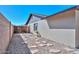 Narrow side yard with stepping stones, gravel, a small window, and a block wall at 3004 W Anderson Dr, Phoenix, AZ 85053