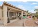 Spacious backyard with covered patio, seating, and brick pavers at 3089 E Hazeltine Way, Chandler, AZ 85249