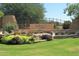 Landscaped Solera community entrance with stone accents and colorful plants welcomes you home at 3089 E Hazeltine Way, Chandler, AZ 85249