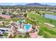 Aerial view of community pool, palm trees, and lush landscaping and golf course at 3089 E Hazeltine Way, Chandler, AZ 85249