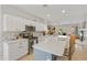 Well-lit kitchen featuring white cabinets, stainless steel appliances, and an island with seating at 3089 E Hazeltine Way, Chandler, AZ 85249